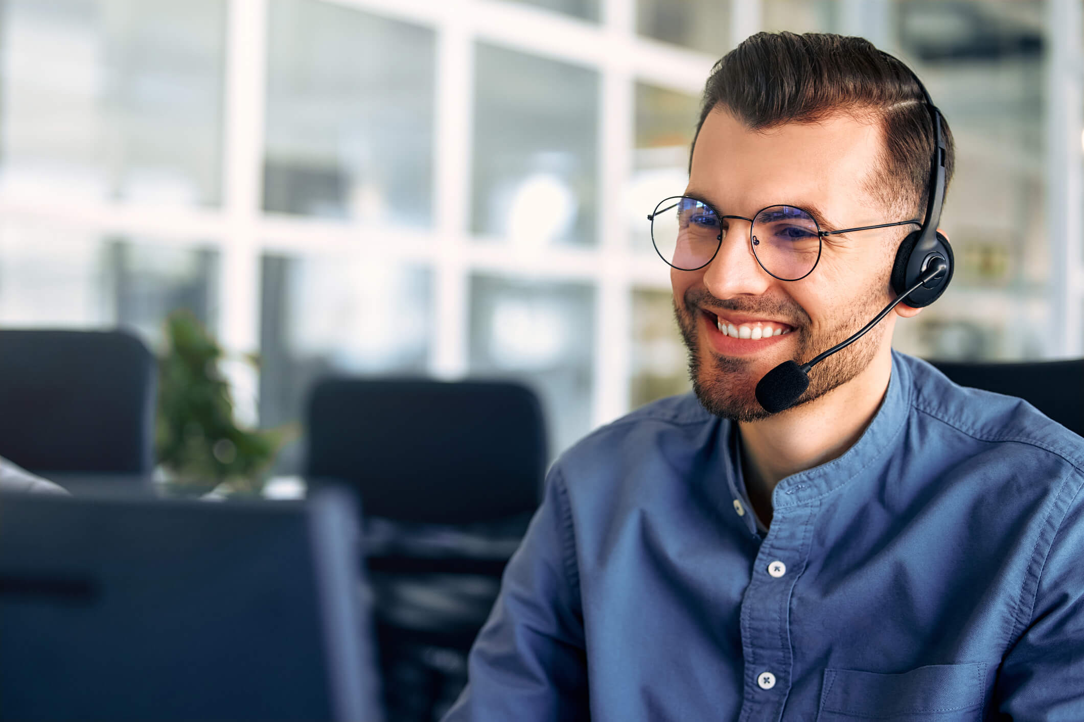 A call center worker sitting at a laptop in the office