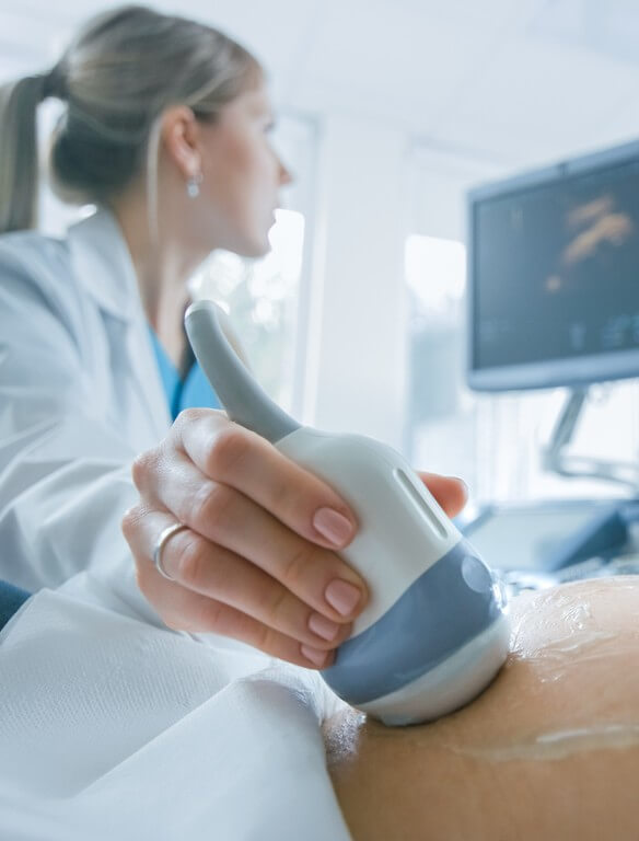 Close-up Shot of the Doctor does Ultrasound / Sonogram Procedure